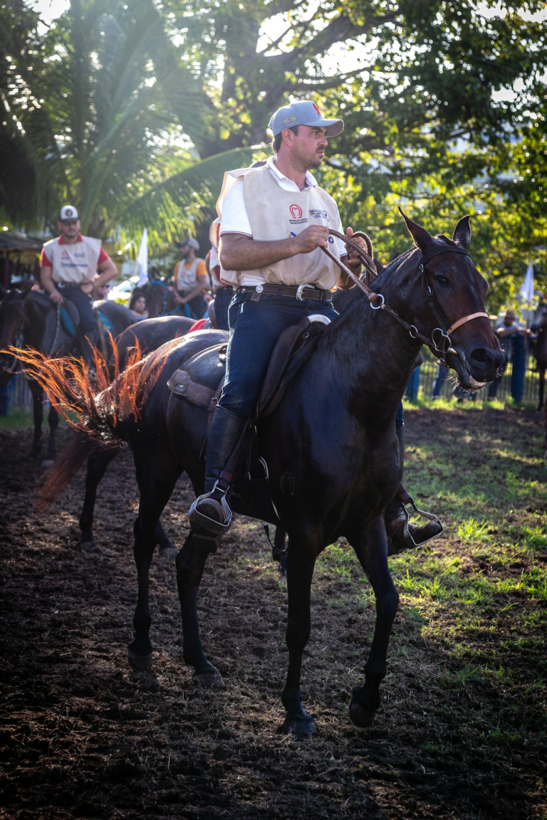 A man rides a horse at an outdoor equestrian event in Recife, Brazil, highlighting skill and enjoyment.
